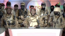 In this image from video broadcast by RTB state television, coup spokesman Capt. Kiswendsida Farouk Azaria Sorgho reads a statement in a studio in Ougadougou, Burkina Faso, on Friday evening, Sept. 30, 2022. Members of Burkina Faso's army seized control of state television late Friday, declaring that the country's coup leader-turned-president, Lt. Col. Paul Henri Sandaogo Damiba, had been overthrown after only nine months in power. The statement announced that Capt. Ibrahim Traore is the new military leader of Burkina Faso, a volatile West African country that is battling a mounting Islamic insurgency. (RTB via AP)