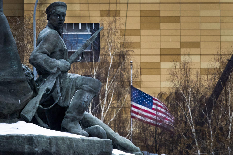 FILE - In this file photo taken on Friday, Dec. 30, 2016, The U.S. Embassy with its national flag, seen behind a monument to the Workers of 1905 Revolution in Moscow, Russia. Russian Foreign Minister Sergey Lavrov says Moscow will order 10 U.S. diplomats to leave Russia in a retaliatory response to the U.S. sanctions. Lavrov also said Moscow will add eight U.S. officials to its sanctions list and move to restrict and stop the activities of U.S. nongovernmental organizations from interfering in Russia's politics. (AP Photo/Alexander Zemlianichenko, File)