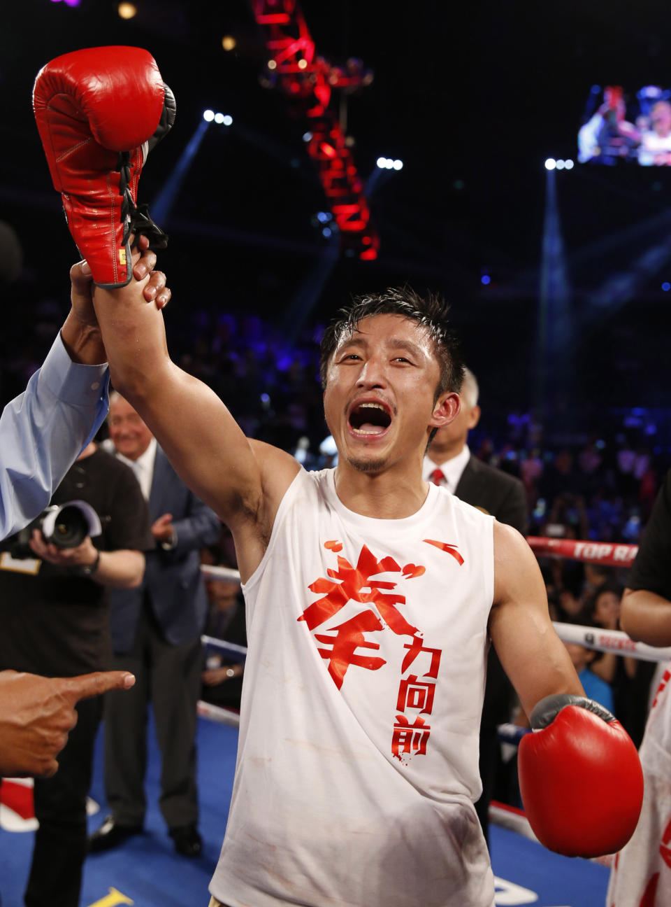 In this July 27, 2013 photo, Chinese boxer Zou Shiming waves to his fans before the Flyweight Bout match against Mexico's Jesus Ortega at the Cotai Arena in Venetian Macao in Macau. The Chinese fighter’s victory at a Macau showdown brings the world’s top casino market a step closer to challenging Las Vegas for dominance of another Sin City staple: big-time boxing matches. Macau, which long ago eclipsed Vegas as the world's top gambling city, is now looking to add to its allure by holding the kind of boxing bouts that Las Vegas is known for. (AP Photo/Dennis Ho)