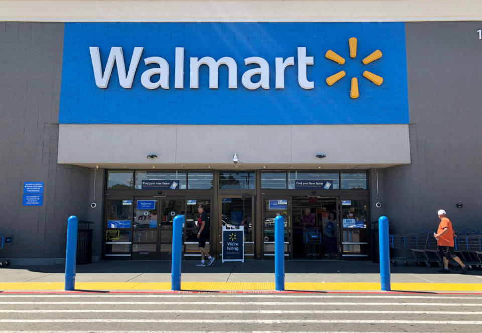 A customer walks towards the entry of a Walmart store in California. 