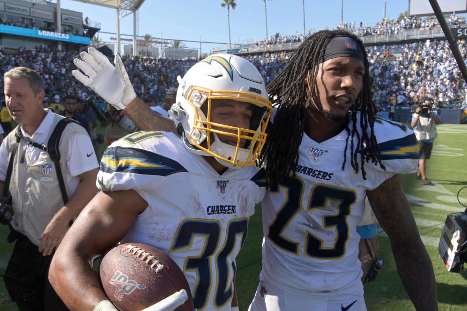Sep 8, 2019; Carson, CA, USA; Los Angeles Chargers running back Austin Ekeler (30) celebrates with defensive back Rayshawn Jenkins (23) after scoring on a 7-yard touchdown run in overtime against the Indianapolis Colts at Dignity Health Sports Park. The Chargers defeated the Colts 30-24 in overtime. Mandatory Credit: Kirby Lee-USA TODAY Sports