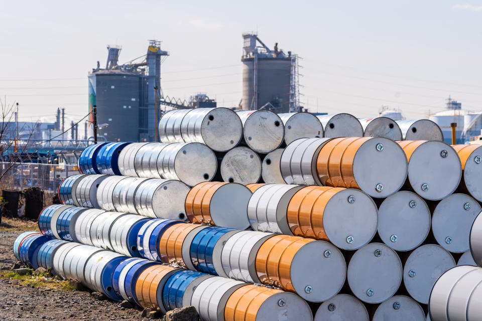 Industry oil chemical metal barrels stacked up in waste yard of tank and container, Kawasaki city near Tokyo Japan