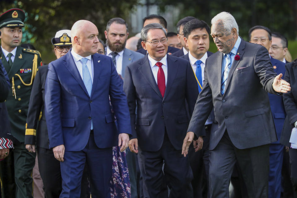 China's Premier Li Qiang, center, stands with New Zealand Prime Minister Christopher Luxon, front left, during the official welcome ceremony in Wellington, New Zealand, Thursday, June 13, 2024. Li has arrived in New Zealand at the start of a weeklong tour that also includes Australia and Malaysia. (Mark Mitchell/NZ Herald via AP)