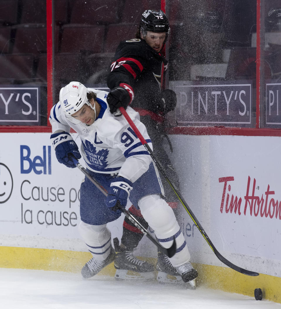 Toronto Maple Leafs center John Tavares knocks Ottawa Senators defenceman Thomas Chabot off the puck during the first period of an NHL hockey game in Ottawa, Ontario, Saturday, Jan. 16, 2021. (Adrian Wyld/The Canadian Press via AP)