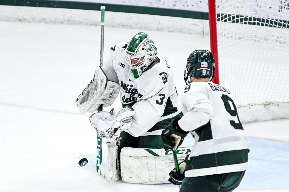 Michigan State's Dylan St. Cyr stops a Michigan shot during the third period on Friday, Dec. 9, 2022, at Munn Arena in East Lansing.