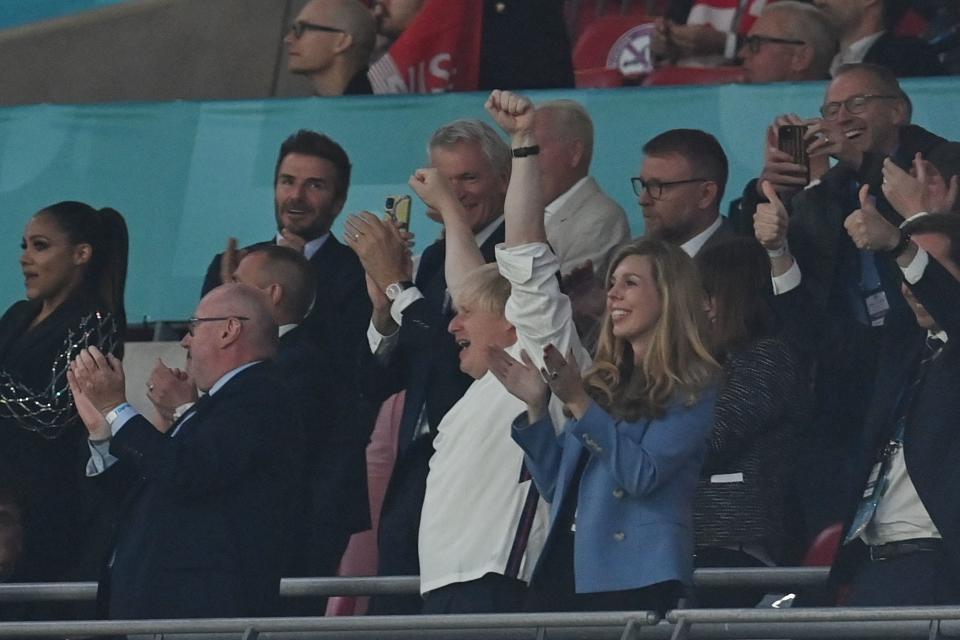 UK Prime Minister Boris Johnson (L) and his spouse Carrie (R) celebrate the second goal during the UEFA EURO 2020 semi-final football match between England and Denmark at Wembley Stadium in London on July 7, 2021. (Photo by Paul ELLIS / POOL / AFP) (Photo by PAUL ELLIS/POOL/AFP via Getty Images)