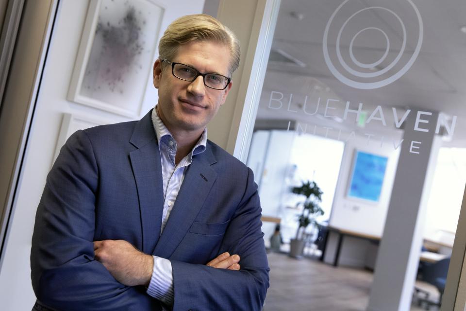 Ian Simmons, Co-Founder and Principal of Blue Haven Initiative, poses at his office in Cambridge, Mass., Friday, Oct. 18, 2019. A handful of billionaires and multimillionaires are making a renewed push for the government to raise their taxes and siphon away some of their holdings. (AP Photo/Michael Dwyer)