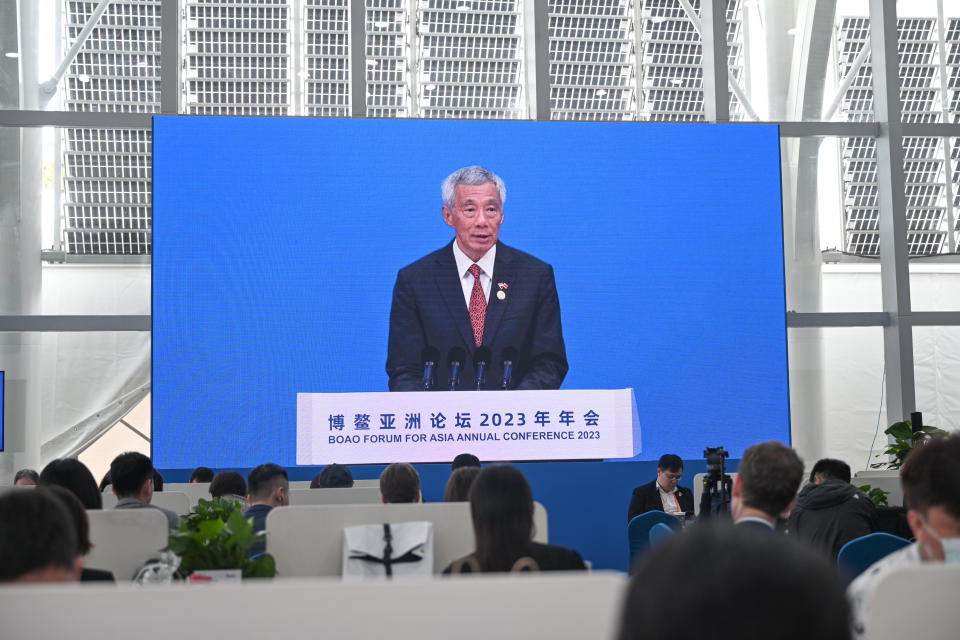 BOAO, CHINA - MARCH 30: Media staff watch a screen showing live broadcast of Singapore's Prime Minister Lee Hsien Loong speaking at the opening plenary of the Boao Forum for Asia Annual Conference 2023 on March 30, 2023 in Boao, Qionghai City, Hainan Province of China. (Photo by VCG/VCG via Getty Images)