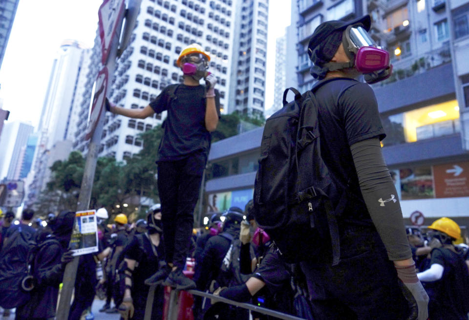 Protesters gather in Central, the main business district in Hong Kong, Sunday, Sept. 8, 2019. Thousands of demonstrators in Hong Kong urge President Donald Trump to “liberate” the semi-autonomous Chinese territory during a peaceful march to the U.S. consulate, but violence broke out later in the business and retail district after protesters vandalized subway stations, set fires and blocked traffic. (AP Photo/Vincent Yu)