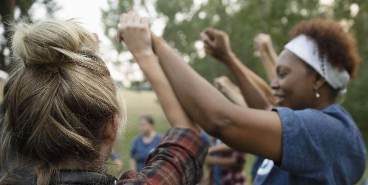 prayers for a friend group of friends holding hands above their heads in a circle