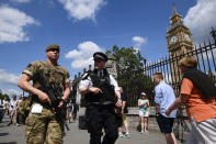 <p>An armed soldier and an armed police officer patrol outside the Houses of Parliament on May 24, 2017 in London, England. 984 military personnel are being deployed around the country as the UK terror status is elevated to Critical in the wake of the Manchester Arena Terror Attack which took place on Monday night. (Carl Court/Getty Images) </p>