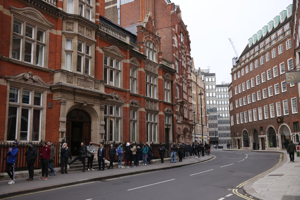 LONDON, ENGLAND - DECEMBER 14: A large queue forms for Covid-19 vaccinations and booster jabs at The Abbey Centre in Westminster on December 14, 2021 in London, United Kingdom. The government announced it was accelerating its Covid-19 booster programme due to concerns about the Omicron variant. The UK now intends to offer every adult a booster jab before the end of the year. (Photo by Dan Kitwood/Getty Images)