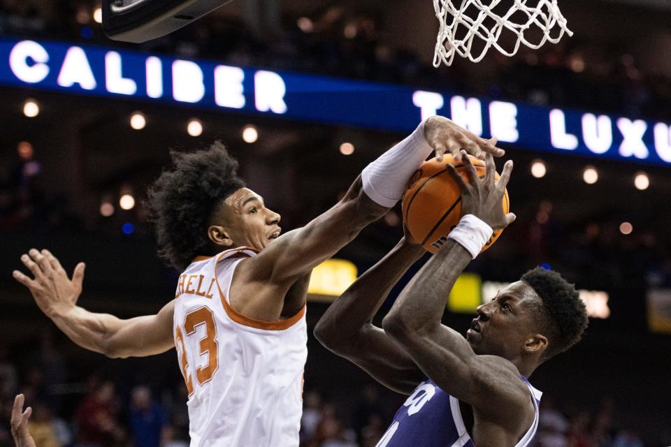 Texas forward Dillon Mitchell, left, blocks a shot by TCU guard Damion Baugh in a Big 12 semifinal at T-Mobile Center in Kansas City. Texas beat the Frogs 66-60 while advancing to the Big 12 tournament title game against Kansas Saturday.