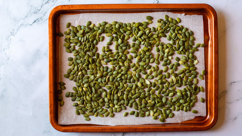 pumpkin seeds on baking sheet
