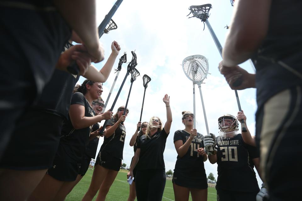 Olivia Friedley, Florida State lacrosse club coach, cheers with the team before their game against BYU in the Women's Collegiate Lacrosse Associates National Championships Wednesday, May 4, 2022, in Round Rock, Texas.