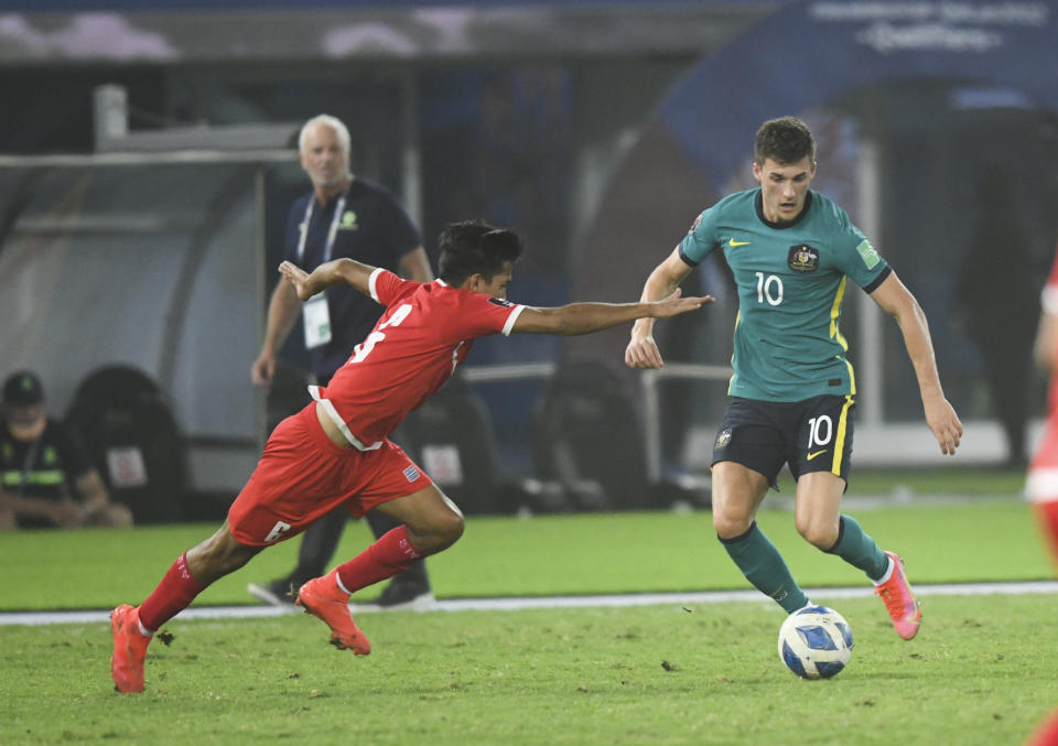 Australia's Ajdin Hrustic, right, and Nepal's Suman Aryal fight for the ball during the World Cup 2022 Group B qualifying soccer match between Nepal and Australia in Kuwait City, Kuwait, Friday. June 11, 2021. (AP Photo/Jaber Abdulkhaleg)