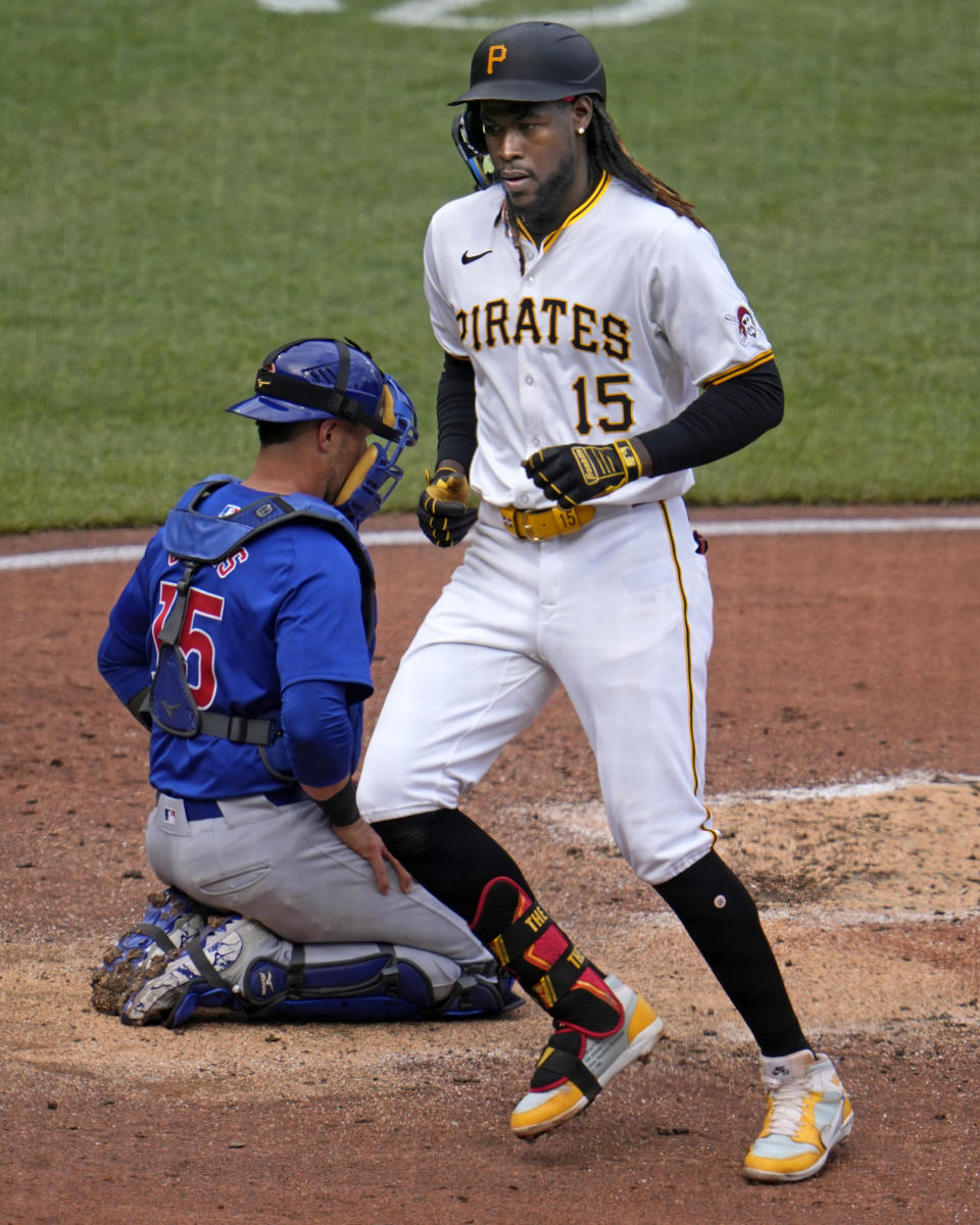 Pittsburgh Pirates' Oneil Cruz, right, crosses home plate in front of Chicago Cubs catcher Yan Gomes, left, after hitting a solo home run off Cubs starting pitcher Justin Steele during the third inning of a baseball game in Pittsburgh, Saturday, May 11, 2024. (AP Photo/Gene J. Puskar)