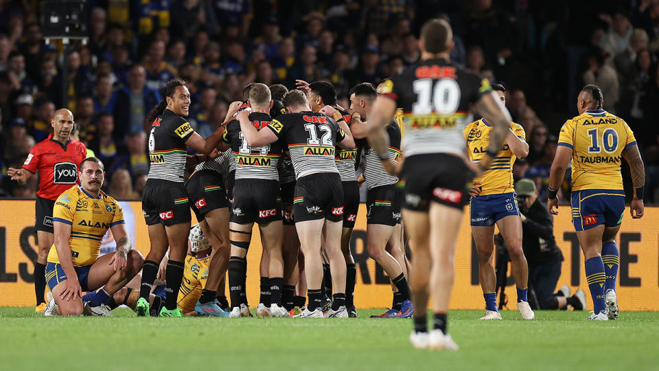 Penrith Panthers players huddle together to celebrate a try against Parramatta in the 2022 NRL Grand Final.