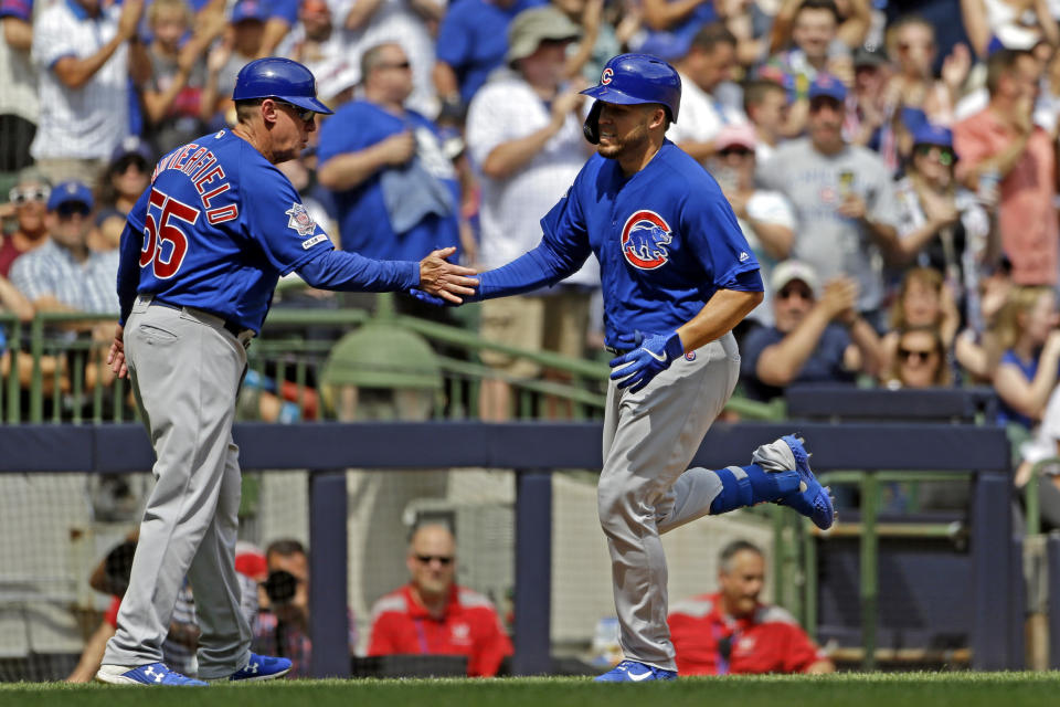 Chicago Cubs' Victor Caratini, right, is congratulated by Brian Butterfield after hitting a three-run home run during the sixth inning of a baseball game against the Milwaukee Brewers, Sunday, July 28, 2019, in Milwaukee. (AP Photo/Aaron Gash)