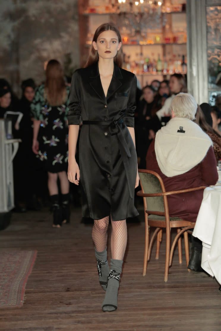 A model walks the Cinq à Sept Fall/Winter 2017 show wearing dark green socks and black heels at Le Coucou Parisian restaurant in New York City. (Photo: Getty)