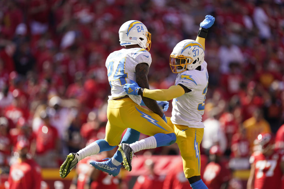 Los Angeles Chargers' Nasir Adderley (24) and Kemon Hall (37) celebrate following an NFL football game against the Kansas City Chiefs, Sunday, Sept. 26, 2021, in Kansas City, Mo. Los Angeles won 30-24. (AP Photo/Charlie Riedel)