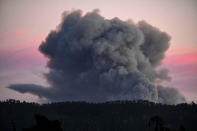 <p>A large plume of smoke from a wildfire rises near Highway 1, burning five miles south of Carmel, Calif., July 22, 2016. (AP Photo/Richard Vogel)</p>