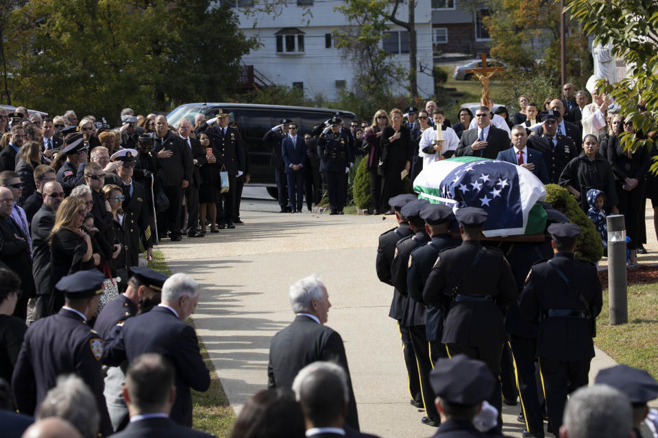 The casket bearing New York City Police Officer Brian Mulkeen is carried into Church of the Sacred Heart, Friday, Oct. 4, 2019, in Monroe, N.Y. Authorities say Mulkeen was fatally hit Sunday by two police bullets while struggling with an armed man in the Bronx. He is the second New York City officer killed by friendly fire this year. (AP Photo/Mark Lennihan)