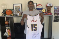 Former ABA/NBA Nuggets great David Thompson holds up a jersey of two-time MVP Nikola Jokic at his home in Charlotte, N.C., on Thursday, May 25, 2023. Thompson is a big fan of Jokic and the Nuggets as they get set to play in their first NBA Finals. (Courtesy of David Thompson via AP).