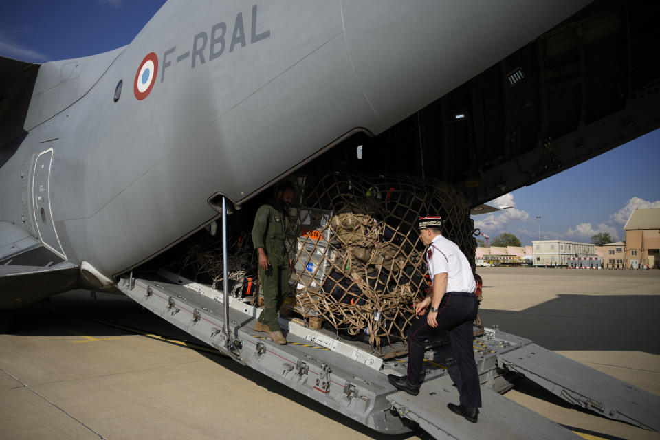 A Civil Security officer walks to a cargo plane loaded with disaster relief for Libya, Wednesday, Sept. 13, 2023 at the Istres military base, southern France. A Libyan local health official said the toll in Libya has reached more than 5,100 dead and is expected to rise further in the eastern city of Derna where floods caused massive devastation over the weekend. French government' s spokesman said a French rescue team of about 50 people aim at being "operational within 48 hours" in Libya. (AP Photo/Daniel Cole)