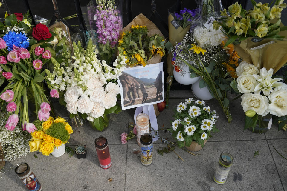 Flowers and candles are placed outside Croft House store in honor of Brianna Kupfer on Tuesday, Jan. 18, 2022, in Los Angeles. The Los Angeles Police Department, West Bureau Homicide detectives are investigating the murder of Kupfer, a 24-year-old Pacific Palisades resident, who was killed at a business in the 300 block of North La Brea Avenue on Jan. 13. (AP Photo/Ashley Landis)