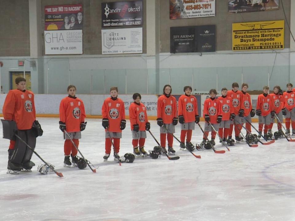 The U13A Strathmore Storm hockey team were chosen to take part in the Orange Jersey project. (Nick Brizuela/CBC - image credit)