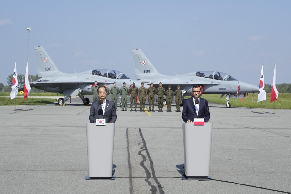 South Korean Prime Minister Han Duck-Soo, left, and his Polish host, Prime Minister Mateusz Morawiecki, right, speak to the media following talks on regional security and the examination of the FA-50 fighter jets that Poland recently bought from South Korea, along with other military equipment, at an air base in Minsk Mazowiecki, eastern Poland, Wednesday, Sept. 13, 2023. Han was in Poland for talks on regional security amid war in neighboring Ukraine, and also to discuss military and nuclear energy cooperation. (AP Photo/Czarek Sokolowski)