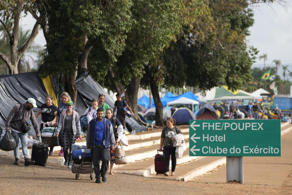 Supporters of Brazil's former President Jair Bolsonaro leave a camp outside the Army headquarters in Brasilia, Brazil, Monday, Jan. 9, 2023. Since Bolsonaro lost re-election to Luiz Inácio Lula da Silva on Oct. 30, his supporters have gathered across the country refusing to concede defeat and asking for the armed forces to intervene. (AP Photo/Eraldo Peres)