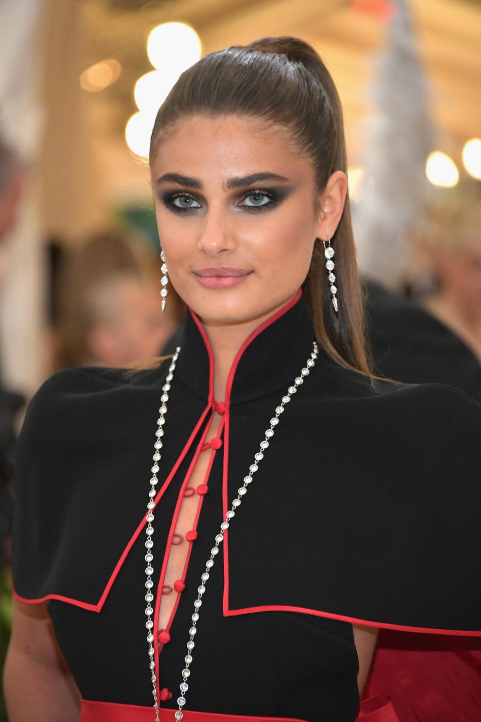 Taylor Hill wearing all black with a high ponytail and dark smoky eye.
