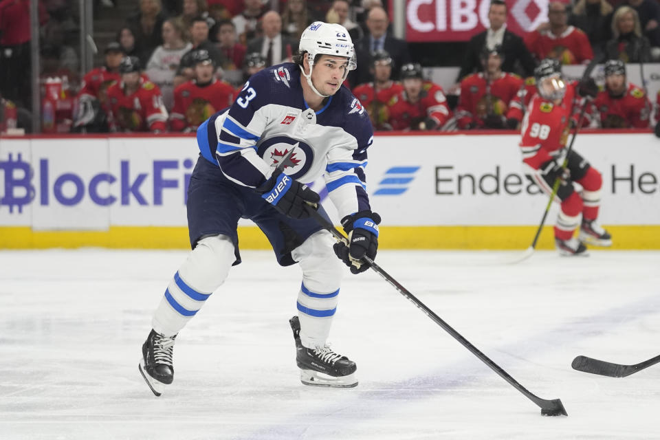 Winnipeg Jets center Sean Monahan works with the puck during the first period of the team's NHL hockey game against the Chicago Blackhawks, Friday, Feb. 23, 2024, in Chicago. (AP Photo/Erin Hooley)