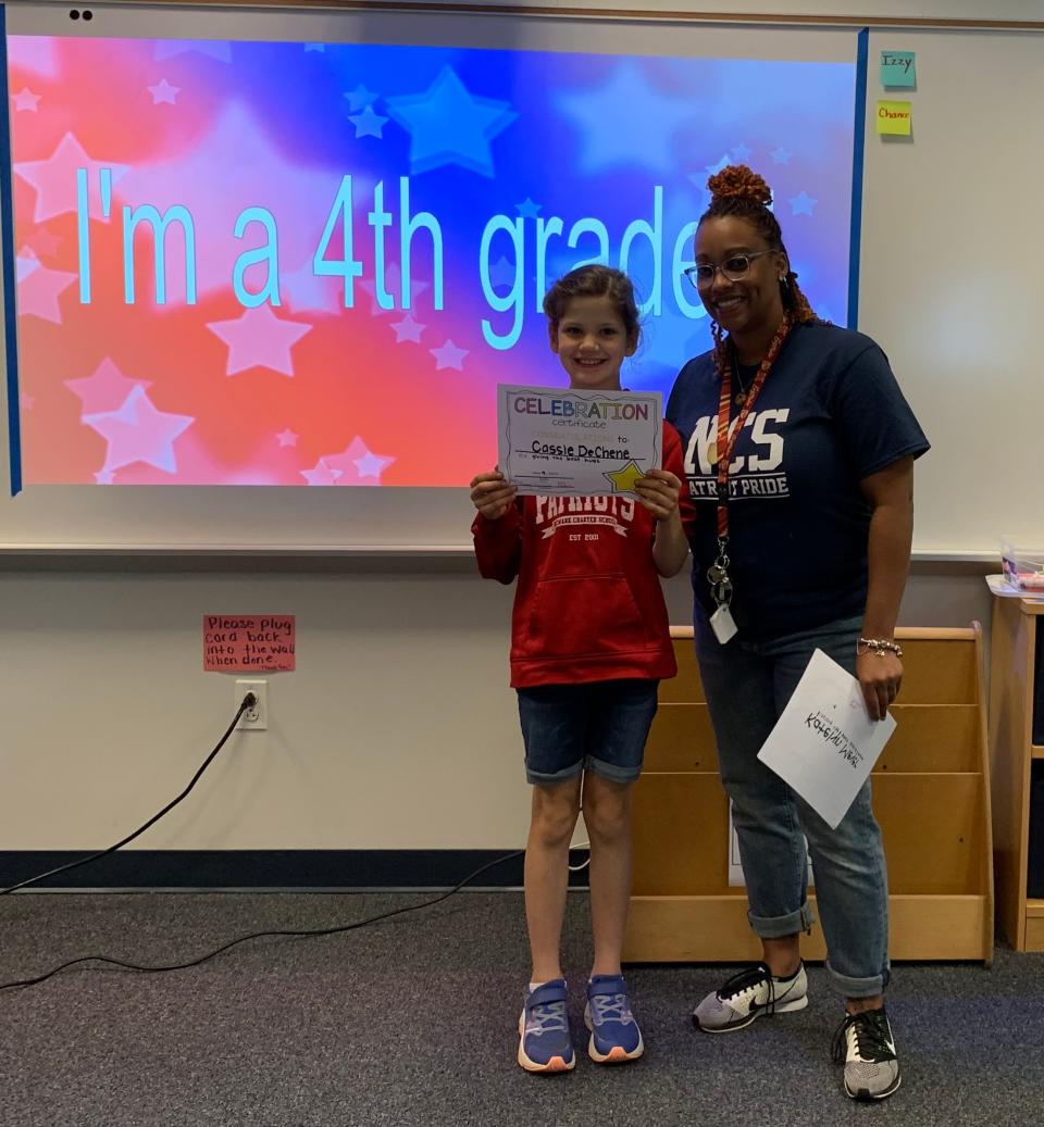 Cassie stands next to her current teacher at Newark Charter, Chalisa McCray.