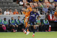 Houston Dynamo defender Tim Parker (5) and Seattle Sounders forward Fredy Montero (12) both go for a header during the first half of an MLS soccer match Saturday, Oct. 16, 2021, in Houston. (AP Photo/Michael Wyke)