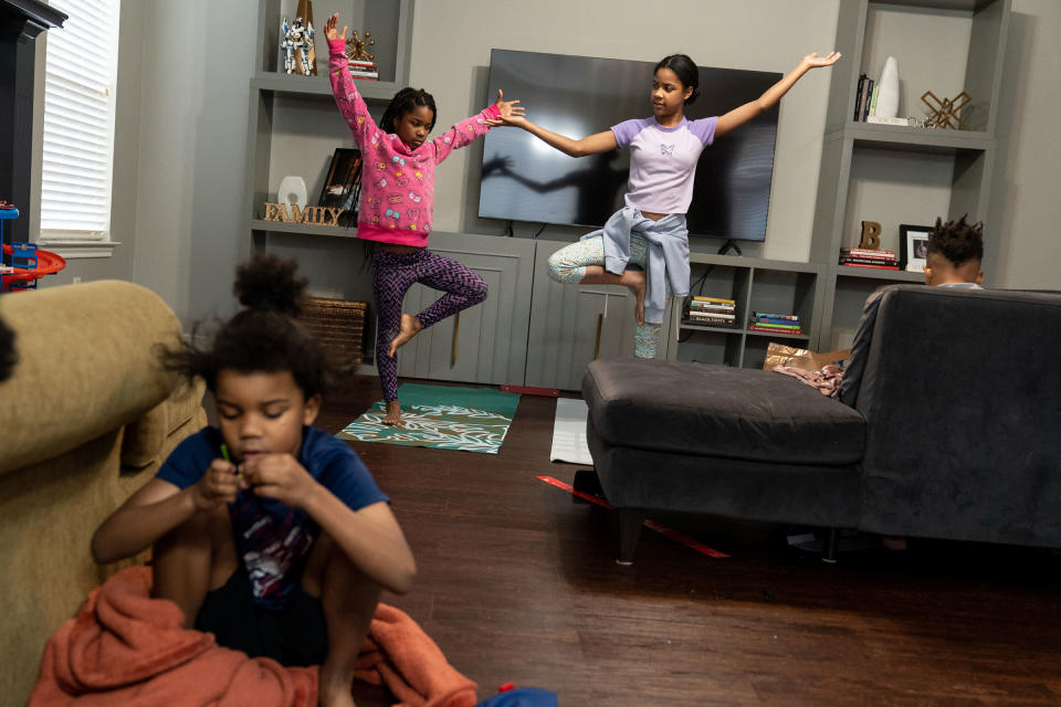 Bellamy, 8, and Brea, 12, do yoga in the living room.<span class="copyright">Ilana Panich-Linsman for TIME</span>