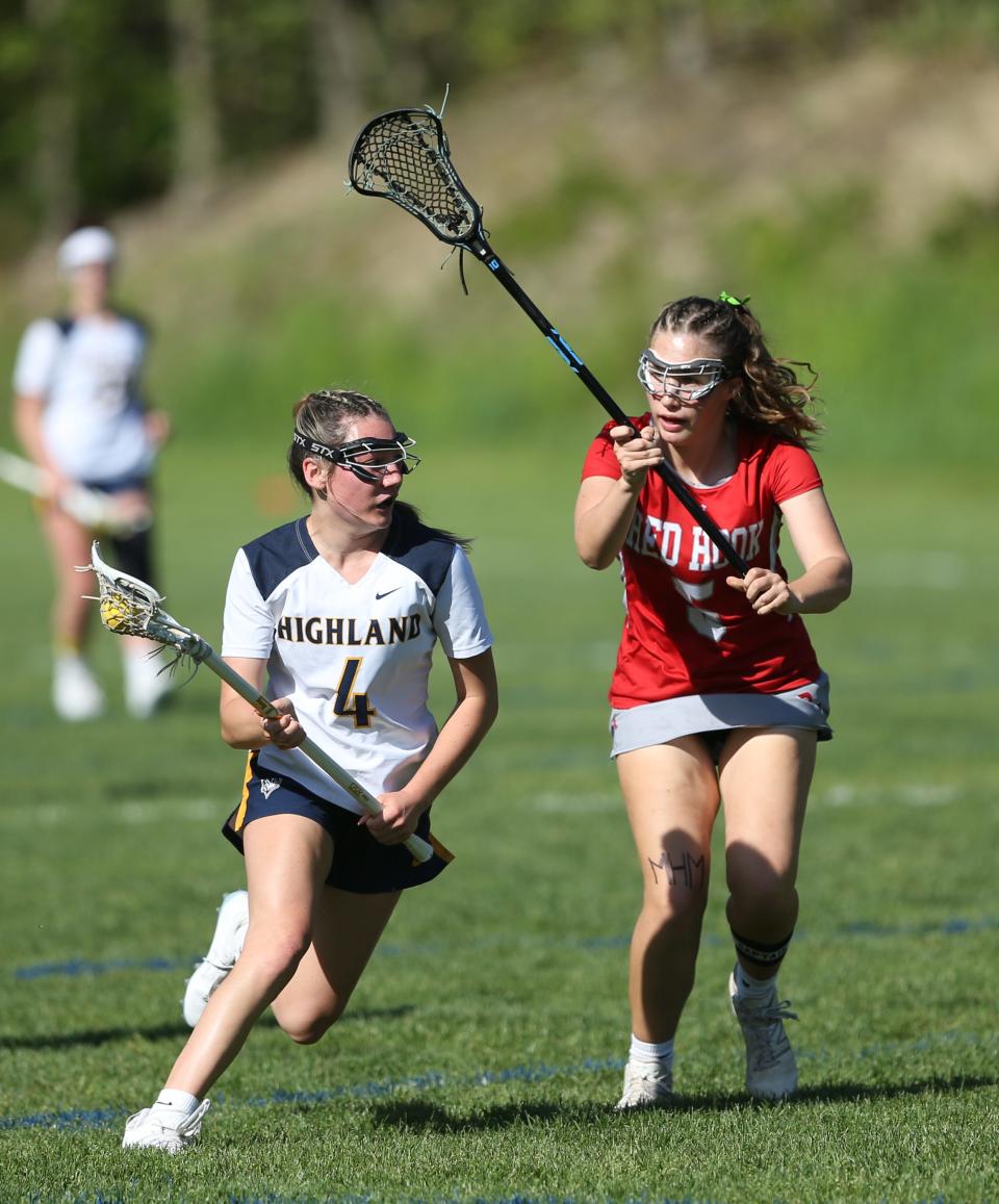 Highland's Logan VanZandt drives against Red Hook's Illa Defraites Scott during a May 8, 2024 girls lacrosse game.
