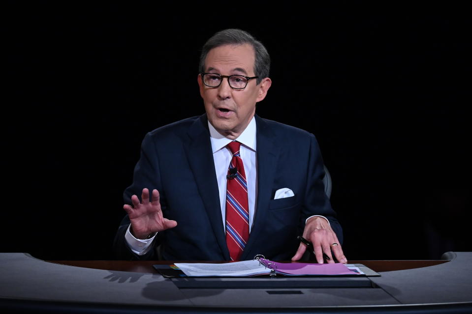 FILE - Moderator Chris Wallace of Fox News speaks as President Donald Trump and Democratic presidential candidate former Vice President Joe Biden participate in the first presidential debate in Cleveland on Sept. 29, 2020. Leaders of the Commission on Presidential Debates and moderators of all three debates gathered for a remote debrief Monday night. Two takeaways: increased early voting means the commission is considering earlier debates, and the mute button may be here to stay. (Olivier Douliery/Pool via AP, File)