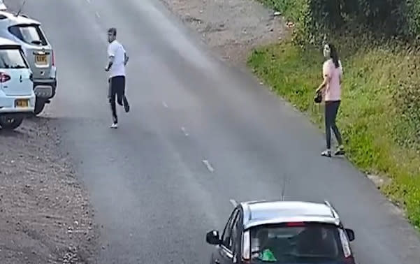 A second male, left, is then seen running from where the Renault crashed