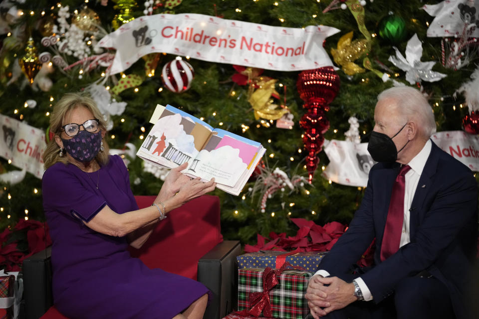 First lady Jill Biden, accompanied by President Joe Biden, reads "The Snowy Day" by Ezra Jack Keats at Children's National Hospital in Washington, Friday, Dec. 23, 2022. (AP Photo/Andrew Harnik)