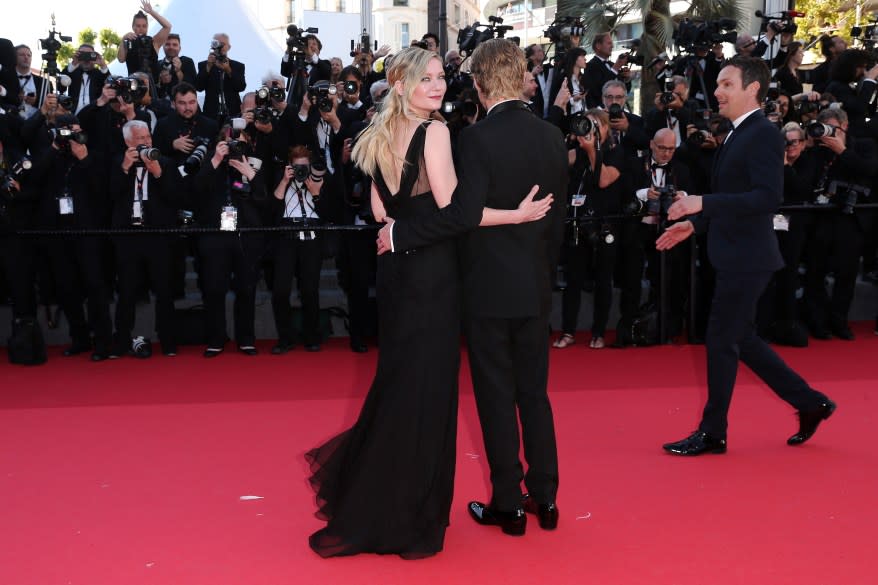 Kirsten Dunst and Jesse Plemons hugging on the red carpet at the 77th annual Cannes Film Festival