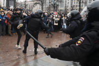 FILE - In this Jan. 23, 2021, file photo, a demonstrator clashes with a police officer during a protest against the jailing of opposition leader Alexei Navalny in Pushkin square in Moscow, Russia. Allies of Navalny are calling for new protests next weekend to demand his release, following a wave of demonstrations across the country that brought out tens of thousands in a defiant challenge to President Vladimir Putin. (AP Photo/Victor Berezkin, File)