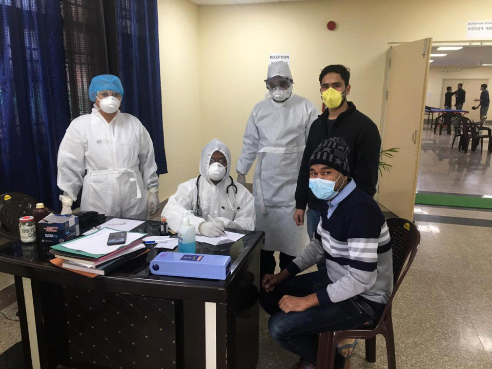 In this handout photo provided by the Indo-Tibetan Border Police (ITBP) shows Indian nationals who were airlifted from coronavirus-hit Hubei province of Chinas Wuhan, undergo tests inside a quarantine facility set by up ITBP, at Chhawla area of New Delhi.