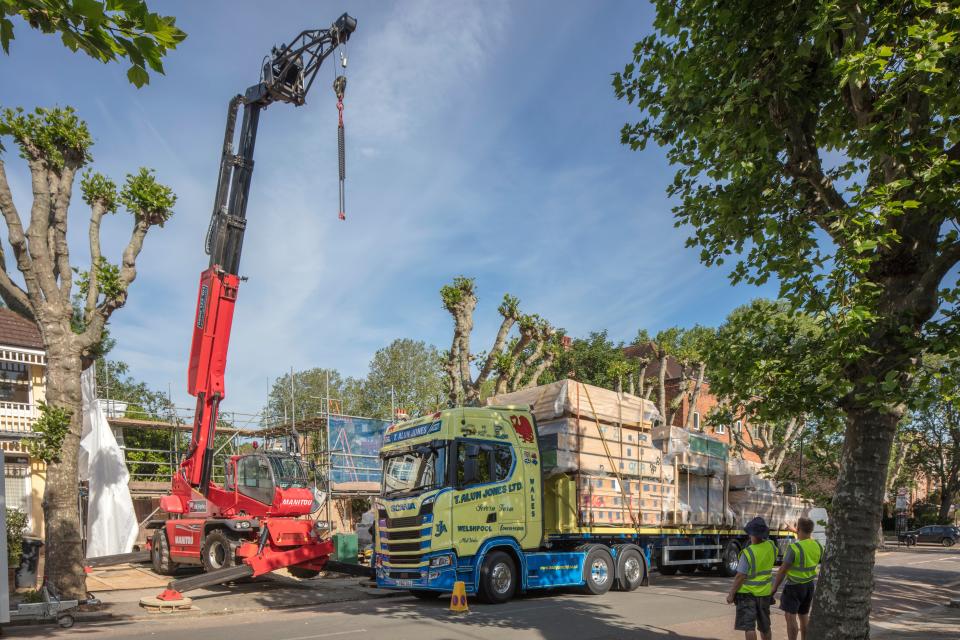 Piece by piece: carpenters in Welshpool created the timber house, which arrived on three lorries this week (Morley von Sternberg)