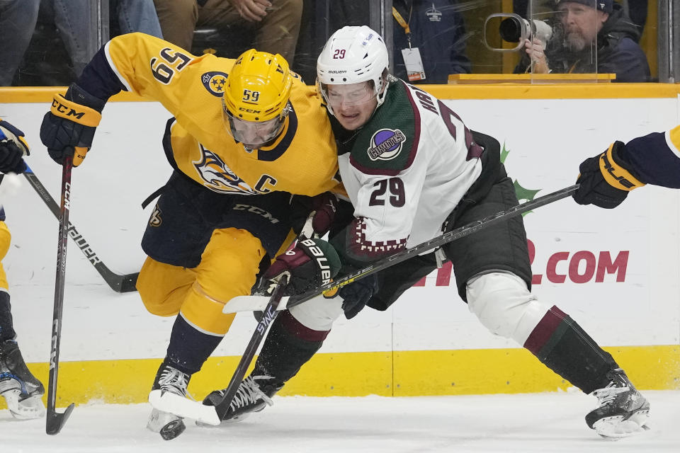 Nashville Predators' Roman Josi (59) and Arizona Coyotes' Barrett Hayton (29) battle for the puck in the first period of an NHL hockey game Monday, Nov. 21, 2022, in Nashville, Tenn. (AP Photo/Mark Humphrey)