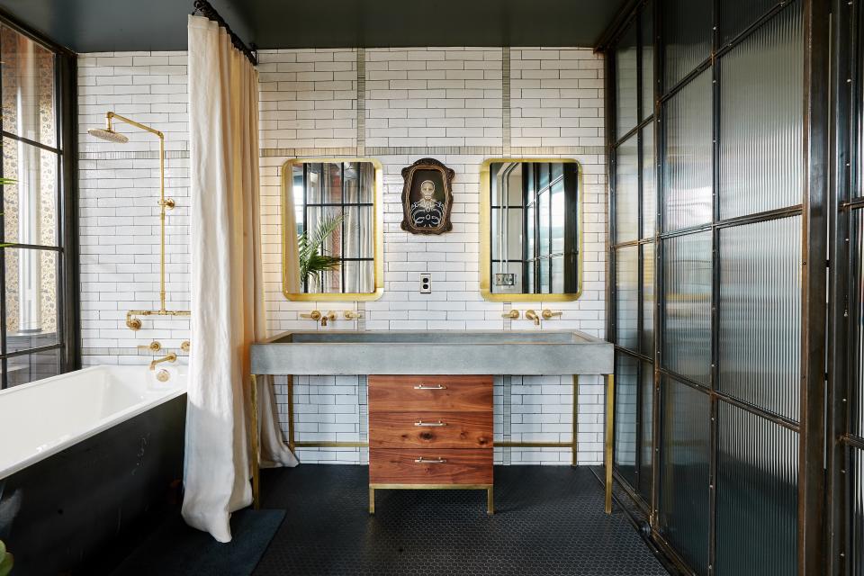 The custom vanity and sink were designed by Ingram, using a sink from Elegant Earth, a brass stand from Puzio's Iron Studio, and walnut drawers from Subeau. The painting is from Museum of Wonder, which is a former taxidermy shop and artifact room.