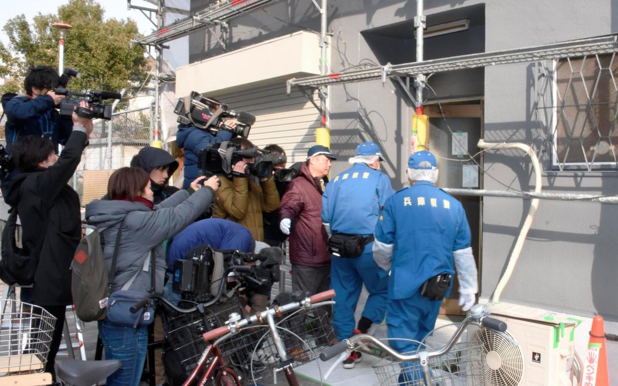 Forensics police officers enter the flat where the head was found - REUTERS