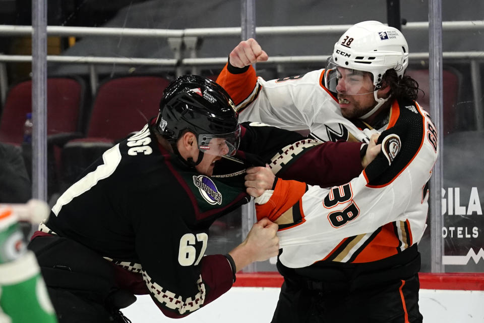 Arizona Coyotes left wing Lawson Crouse (67) and Anaheim Ducks center Derek Grant (38) fight in the first period during an NHL hockey game, Monday, Feb. 22, 2021, in Glendale, Ariz. (AP Photo/Rick Scuteri)